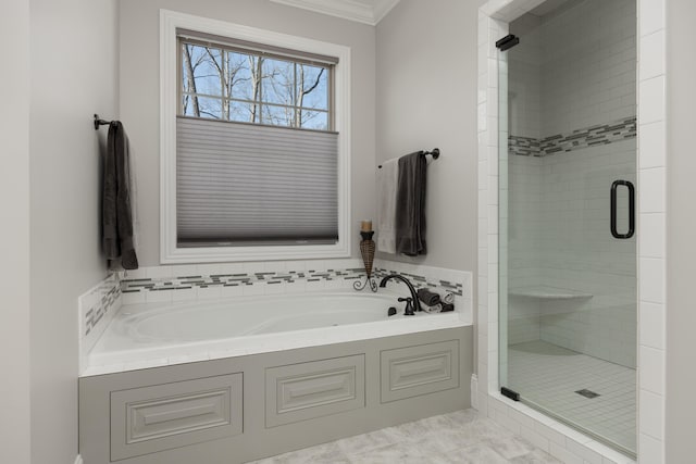 bathroom featuring ornamental molding and independent shower and bath