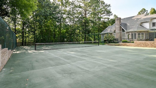 view of sport court featuring fence