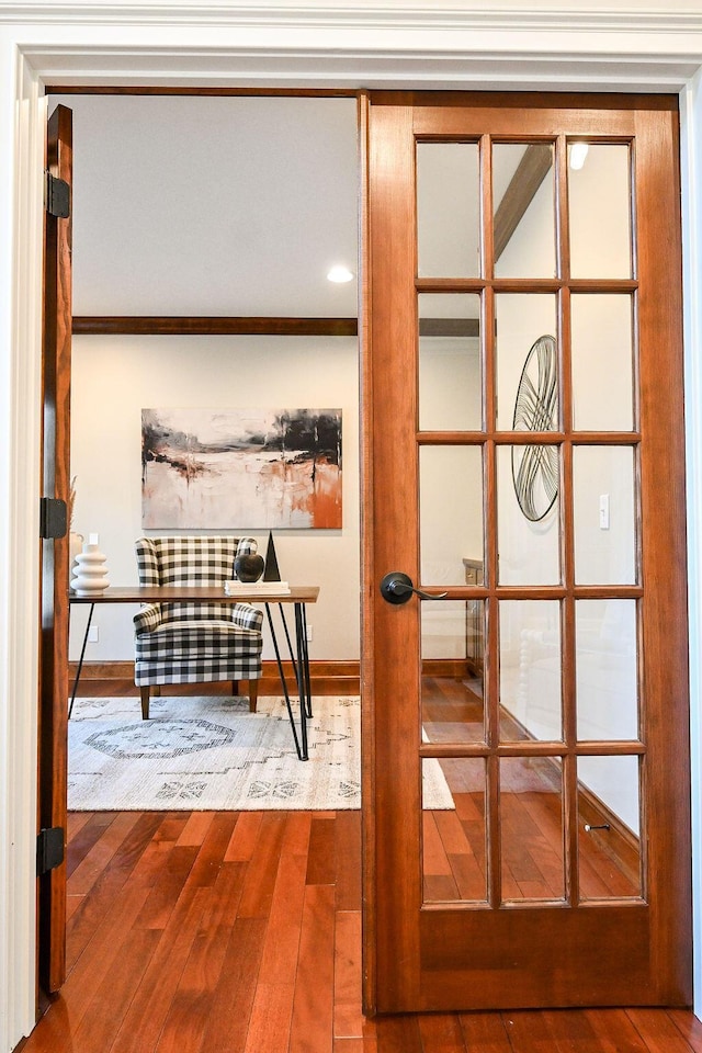 doorway to outside with french doors, baseboards, and wood finished floors