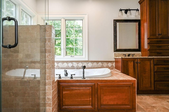 bathroom with shower with separate bathtub, vanity, and plenty of natural light