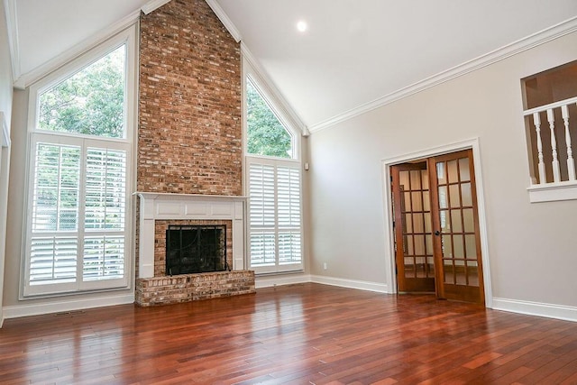 unfurnished living room with a brick fireplace, high vaulted ceiling, and dark hardwood / wood-style flooring