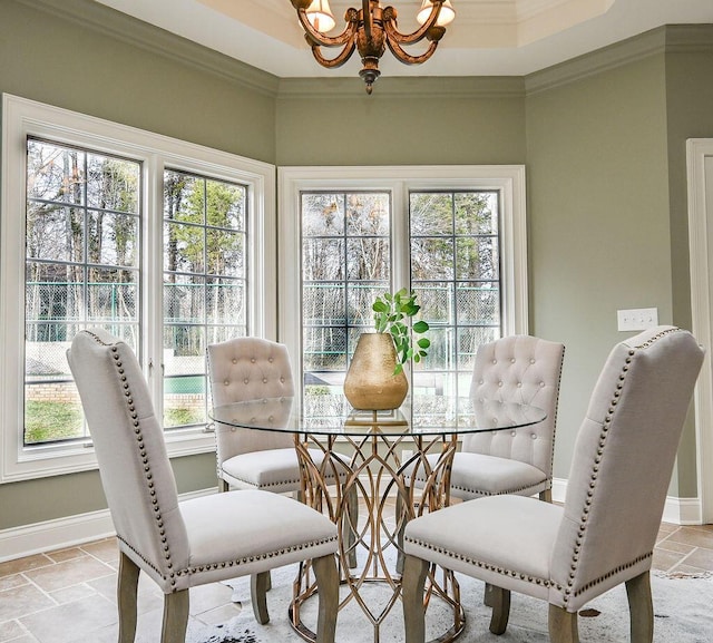 dining space featuring baseboards, stone tile floors, ornamental molding, and a notable chandelier