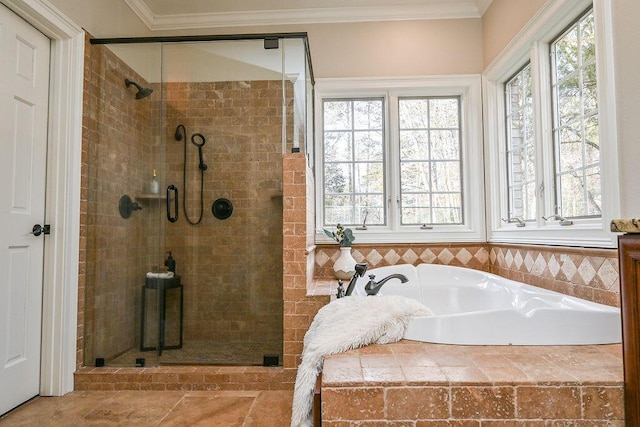 bathroom with a garden tub, a shower stall, and crown molding