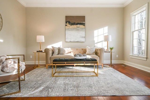 living room with a wealth of natural light, crown molding, and wood finished floors