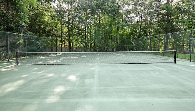 view of sport court featuring fence