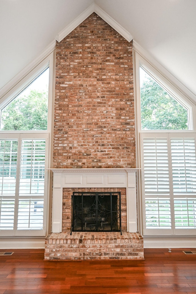 details with a fireplace, ornamental molding, and wood-type flooring