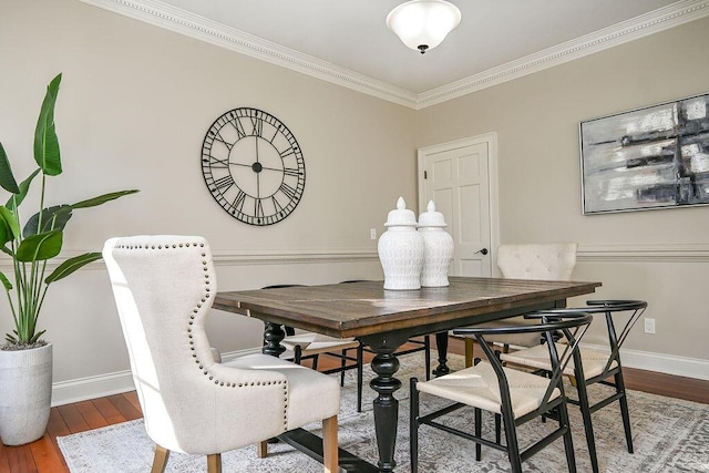 dining area with ornamental molding, wood finished floors, and baseboards