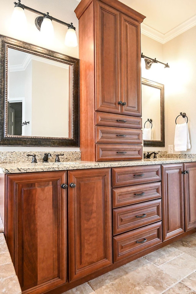 full bathroom with ornamental molding, a sink, and double vanity