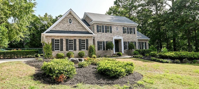 view of front of house with brick siding and a front yard