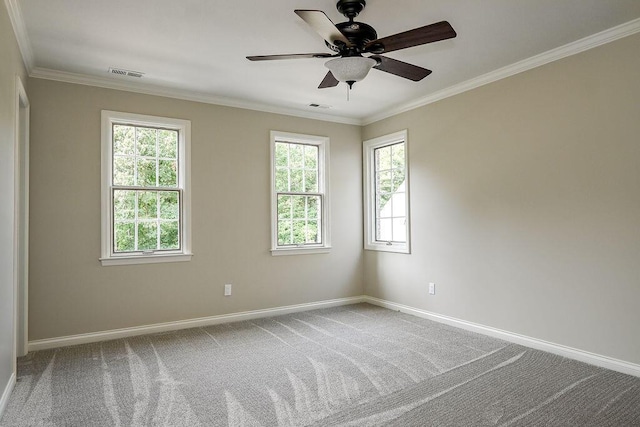 carpeted empty room featuring ornamental molding, visible vents, baseboards, and a ceiling fan