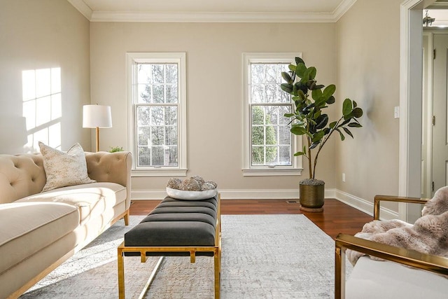 sitting room featuring crown molding, baseboards, and wood finished floors