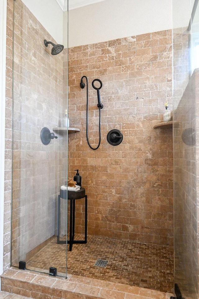 full bath featuring ornamental molding and tiled shower