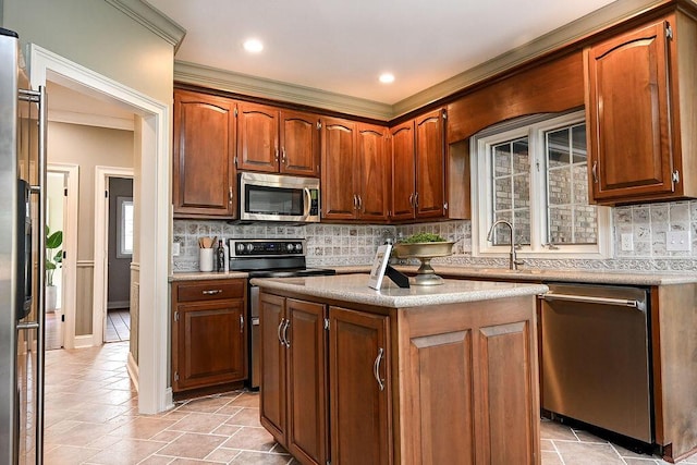 kitchen with stainless steel appliances, light countertops, backsplash, brown cabinetry, and a kitchen island