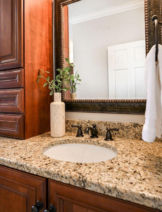 bathroom with vanity and crown molding