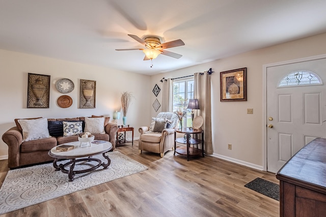 living room with ceiling fan and light wood-type flooring