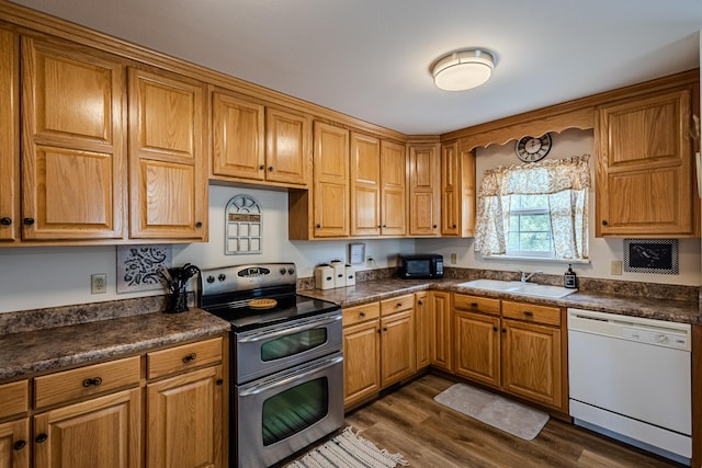 kitchen with white dishwasher, dark hardwood / wood-style flooring, stainless steel electric range oven, and sink