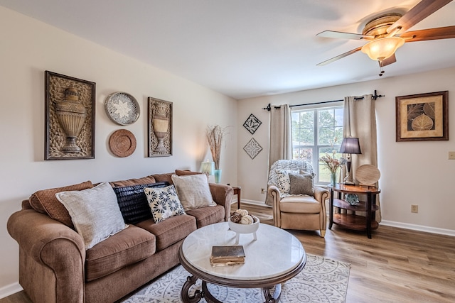 living room featuring ceiling fan and light hardwood / wood-style flooring