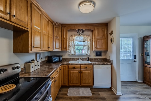 kitchen featuring white dishwasher, dark hardwood / wood-style floors, sink, and stainless steel electric stove