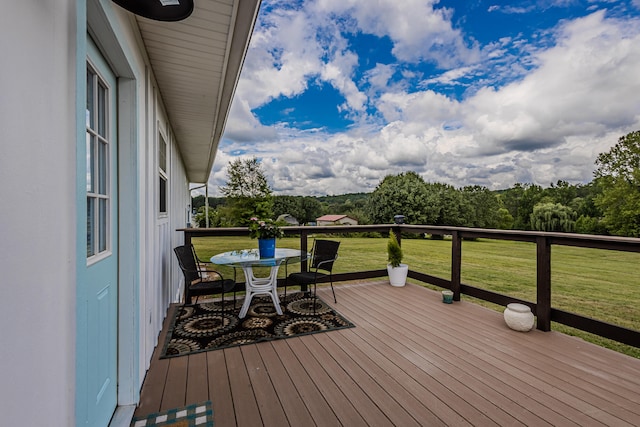 wooden terrace featuring a lawn