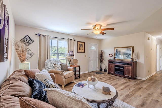 living room with ceiling fan and light hardwood / wood-style floors