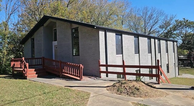 view of side of home featuring a yard