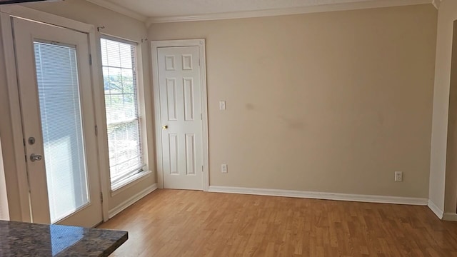 entryway with crown molding and wood-type flooring