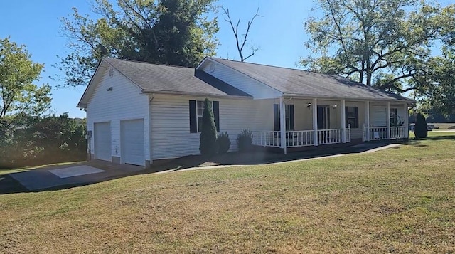 ranch-style home featuring covered porch, a front yard, and a garage