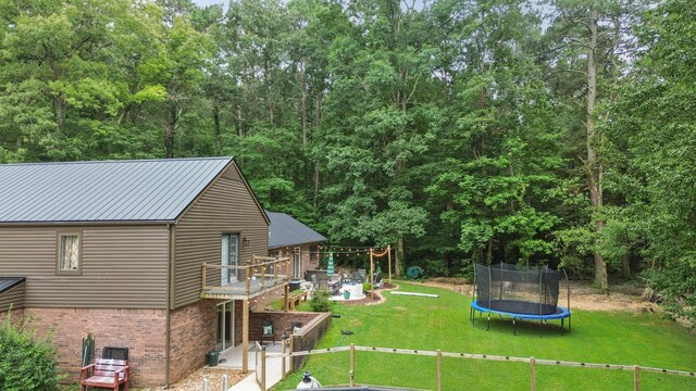 364 Hidden Oaks Trl, Cleveland, TN 37312 - view of green lawn with a trampoline and a deck