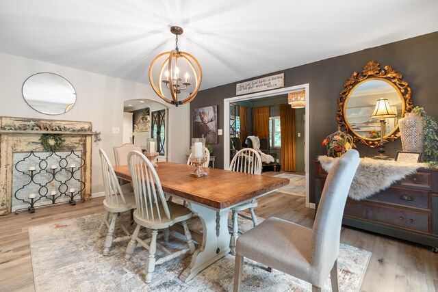 364 Hidden Oaks Trl, Cleveland, TN 37312 - dining room featuring a chandelier, light wood-style flooring, and arched walkways