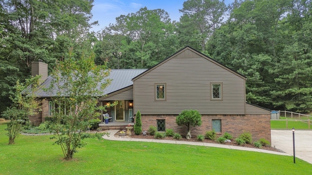364 Hidden Oaks Trl, Cleveland, TN 37312 - view of front of home with a front lawn, brick siding, and a chimney