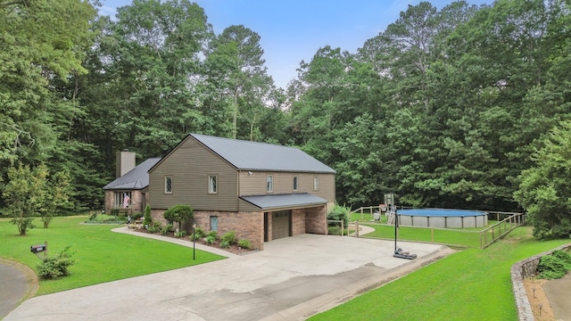 364 Hidden Oaks Trl, Cleveland, TN 37312 - view of side of home featuring a garage, an outdoor pool, brick siding, a chimney, and driveway