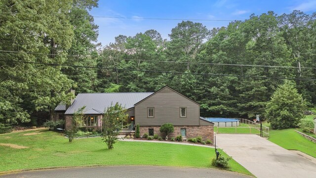 364 Hidden Oaks Trl, Cleveland, TN 37312 - split level home featuring driveway, a front lawn, a metal roof, brick siding, and a chimney