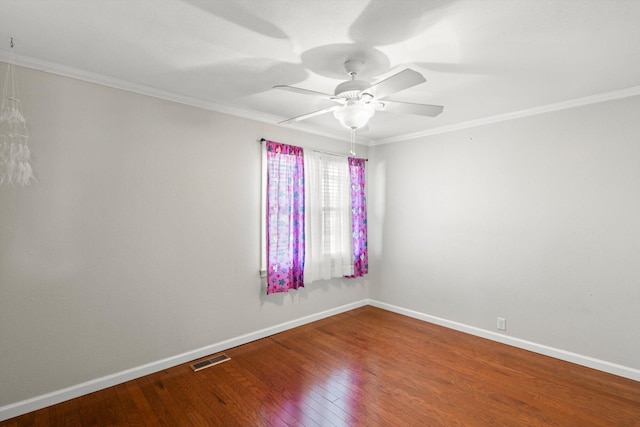 spare room with ceiling fan, wood-type flooring, and crown molding