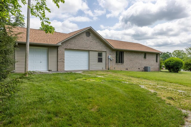 139 County Road 147, Riceville, TN 37370 - back of house featuring roof with shingles, an attached garage, cooling unit, and brick siding
