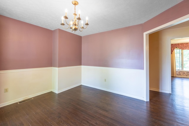 139 County Road 147, Riceville, TN 37370 - unfurnished room with baseboards, a notable chandelier, visible vents, and wood finished floors