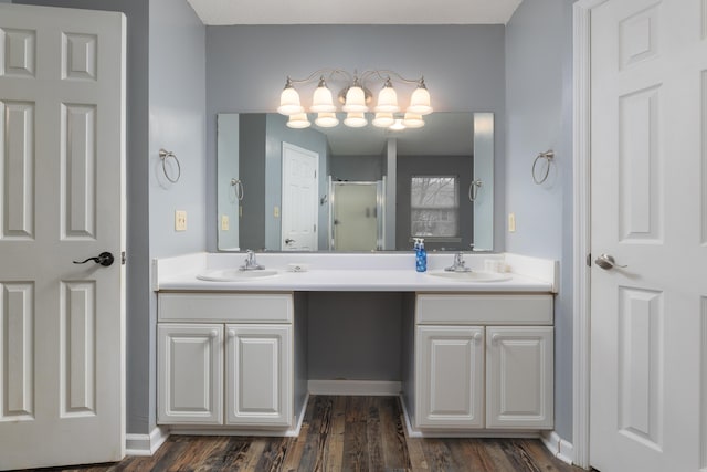 bathroom with vanity, hardwood / wood-style flooring, and a shower with shower door