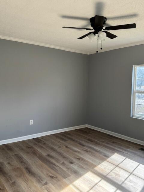 unfurnished room with hardwood / wood-style floors and ornamental molding