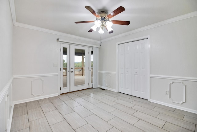 interior space with ceiling fan, crown molding, and french doors