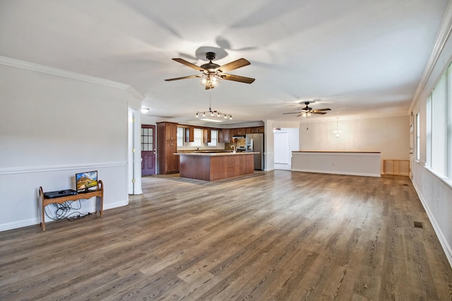 unfurnished living room featuring ceiling fan, dark hardwood / wood-style flooring, and ornamental molding