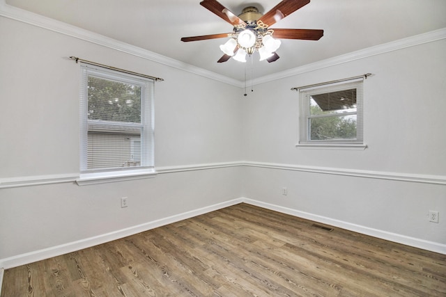 spare room with hardwood / wood-style floors, ceiling fan, and crown molding