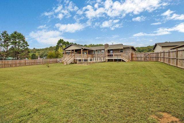 back of property featuring a yard and a deck