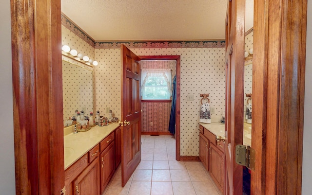 bathroom with tile patterned floors, vanity, and a textured ceiling