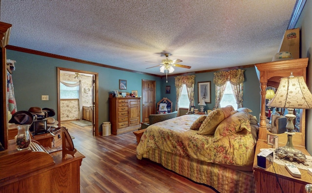 bedroom featuring a textured ceiling, ceiling fan, crown molding, and dark wood-type flooring