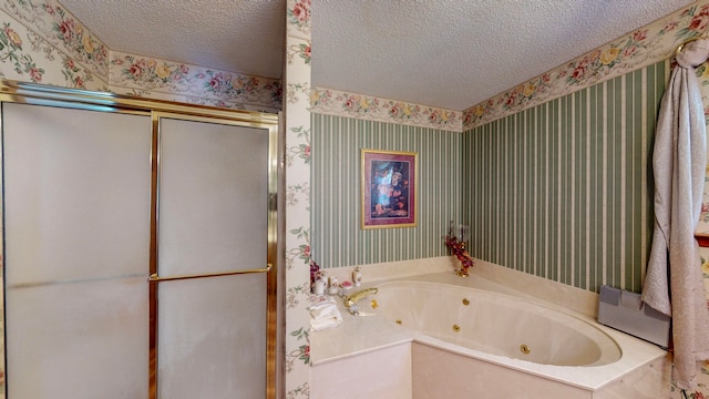 bathroom with shower with separate bathtub and a textured ceiling