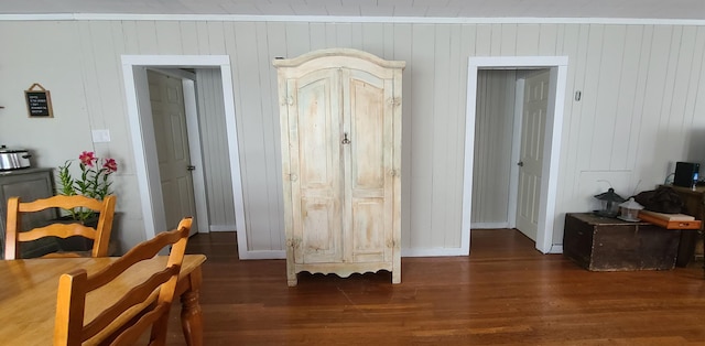 bedroom with baseboards, wood finished floors, and ornamental molding