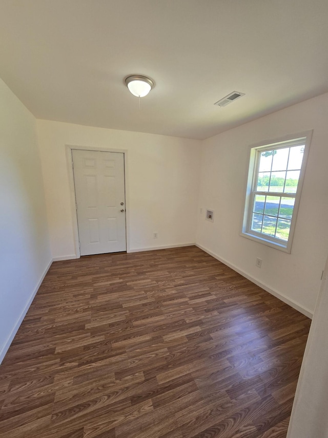 unfurnished room with dark hardwood / wood-style floors