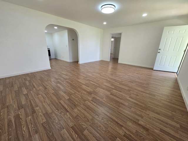 unfurnished room with dark hardwood / wood-style flooring