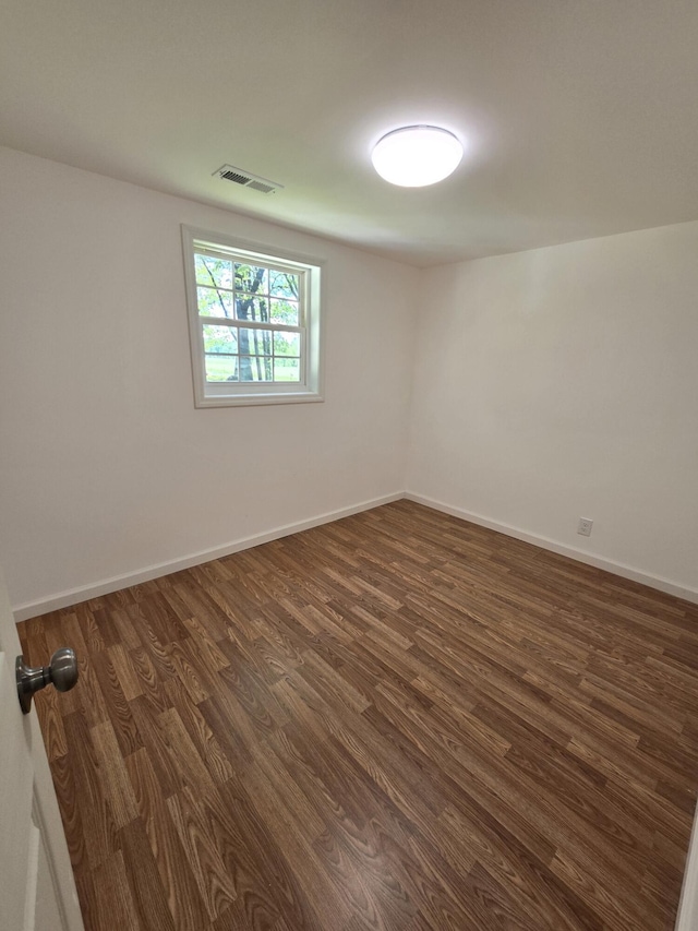 empty room featuring dark wood-type flooring