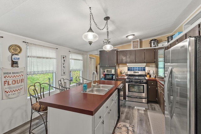 1426 Nebo Rd, Ten Mile, TN 37880 - kitchen with stainless steel appliances, a sink, dark countertops, under cabinet range hood, and ornamental molding