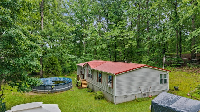 1426 Nebo Rd, Ten Mile, TN 37880 - back of house featuring crawl space, a lawn, metal roof, and a covered pool